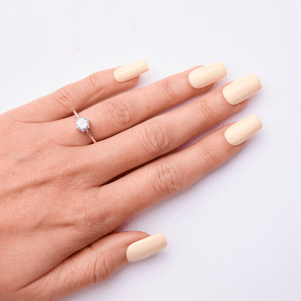 Light nude gel polish applied on nails using Lola Lee Too Sassy For You