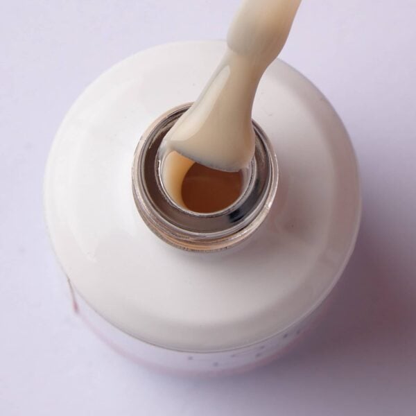 Brush lifting semi-sheer nude gel polish from the bottle
